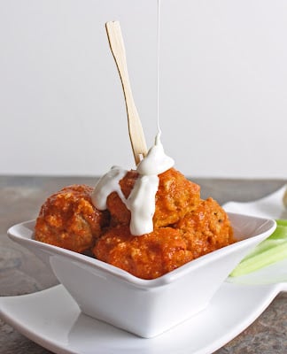 keto buffalo chicken meatballs with a drizzle of blue cheese dressing