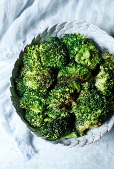 Sriracha Roasted Broccoli in a white pottery bowl shot from above
