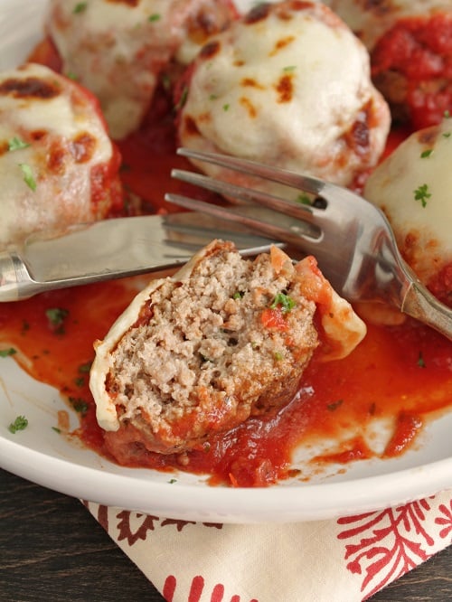 keto meatballs smothered in marinara sauce and mozzarella cheese. 
