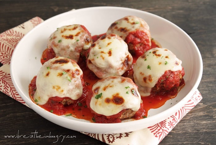 Keto Meatballs alla Parmigiana with sauce and cheese and garnished with parsley