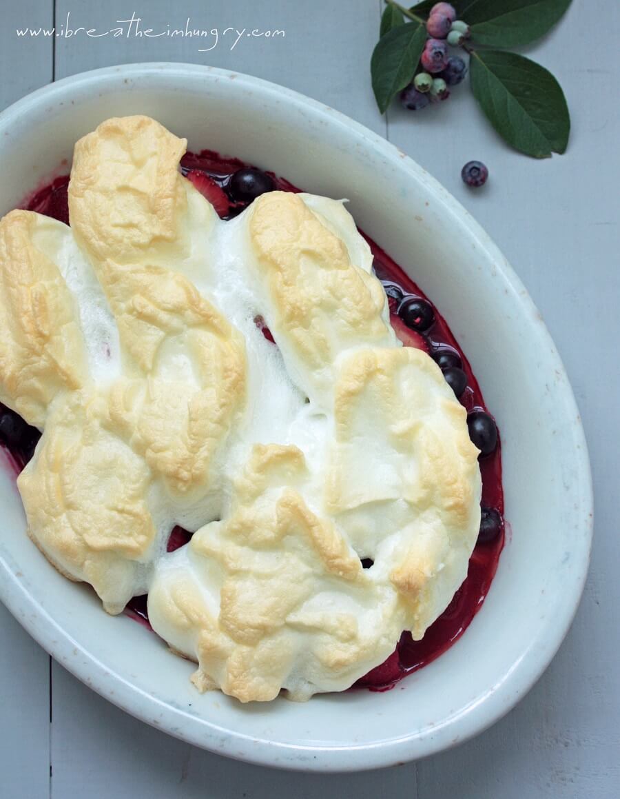 Baked summer berry meringue in a white casserole dish