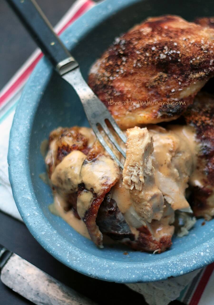 keto baked chicken thighs with sour cream gravy shot from above showing the inside of the juicy meat