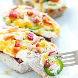 A delicious grilled pork chop (or chicken) smothered in cheese, bacon, and jalapenos - a low carb and keto dream come true.