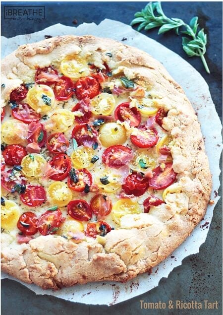 This rustic keto tomato tart boasts creamy ricotta, garlic and herb oil and crispy proscuitto. Low Carb and Gluten Free.