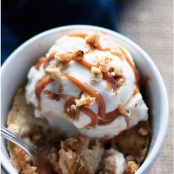 A delicious fall inspired mug cake that is loaded with apples, caramel and walnuts! Low carb and gluten free.