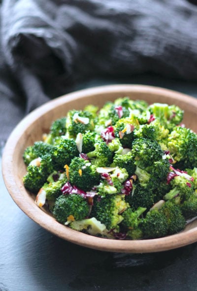 Keto Broccoli Salad in a wooden bowl on a slate background