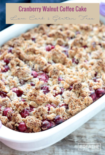 This low carb cranberry walnut coffee cake boasts a subtly orange flavored cake with a burst of tart cranberries & a toasty walnut streusel topping! Keto, Atkins, Gluten Free