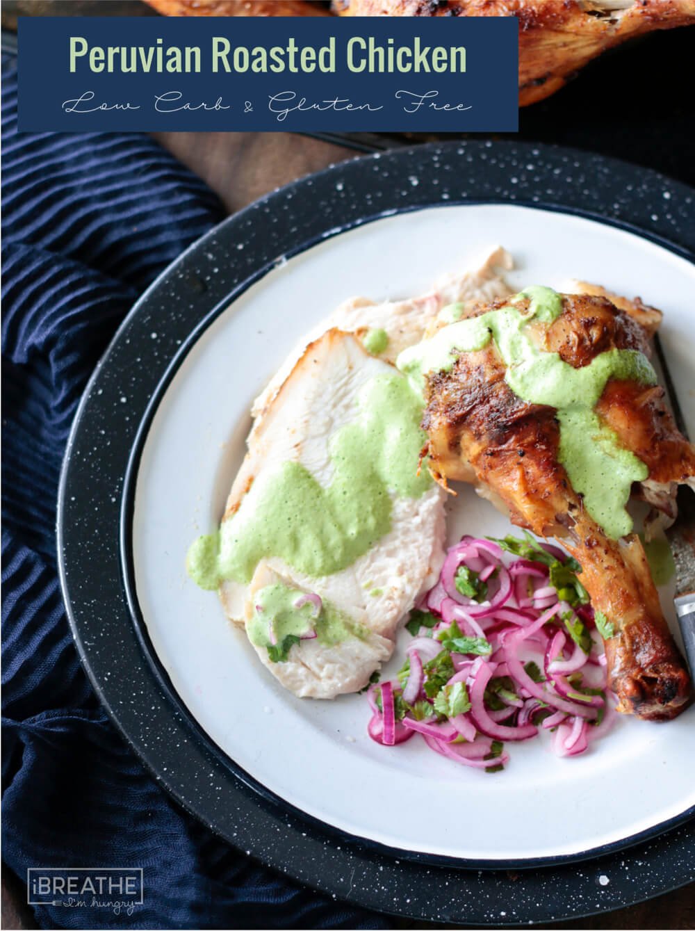 Keto Peruvian Roasted Chicken sliced on a white plate with green sauce and pickled red onions
