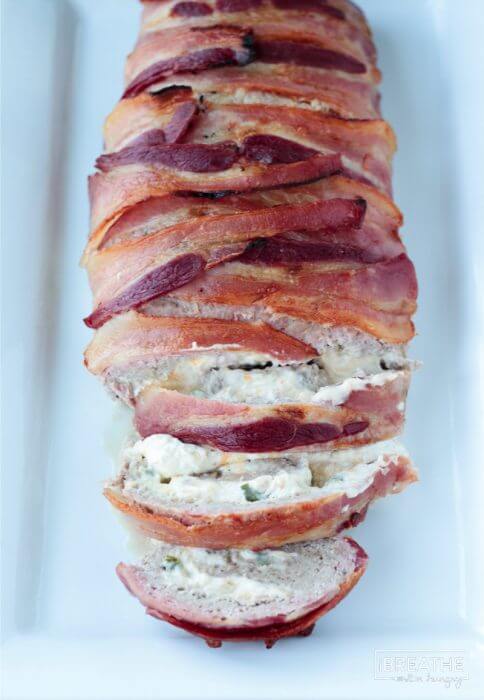 A fantastic pork meatloaf stuffed with jalapeño popper filling and wrapped in bacon!