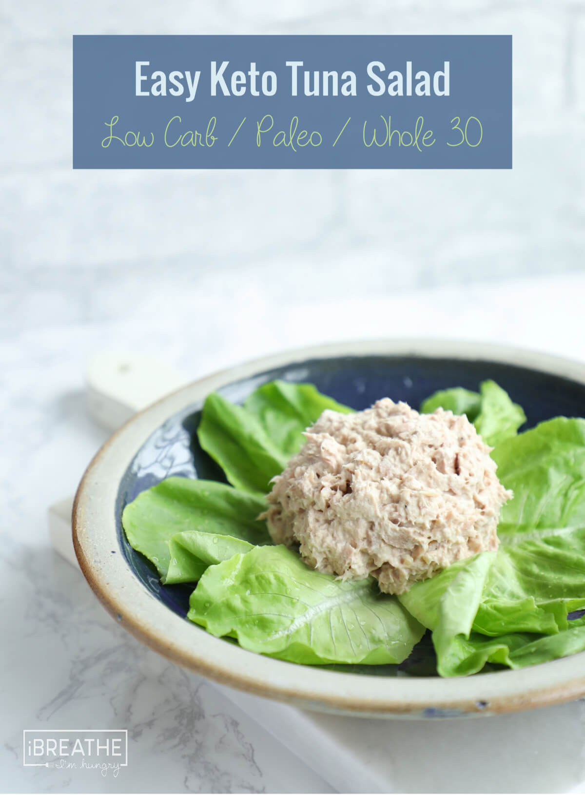 a scoop keto tuna salad shown on a bed of baby romaine lettuce leaves