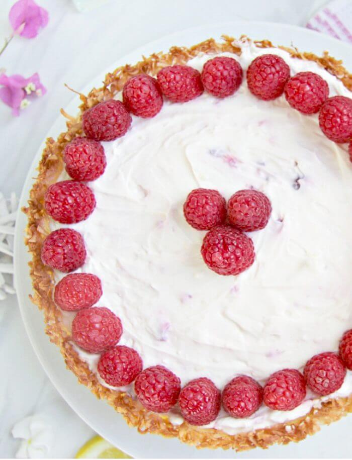 A gorgeous keto raspberry cheesecake recipe with a hint of lemon and a coconut macaroon crust!