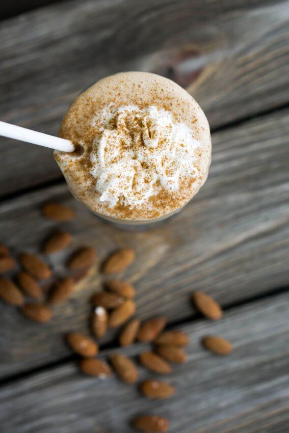 keto cinnamon almond butter breakfast shake with almonds and whipped cream