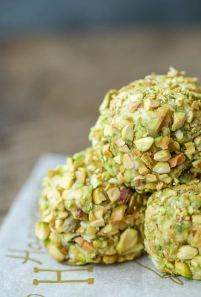 Closeup of 3 stacked Keto Pistachio Truffles on parchment