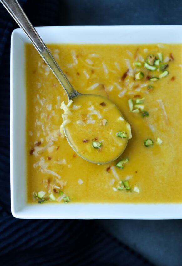 Top view of keto curried squash soup with spoon