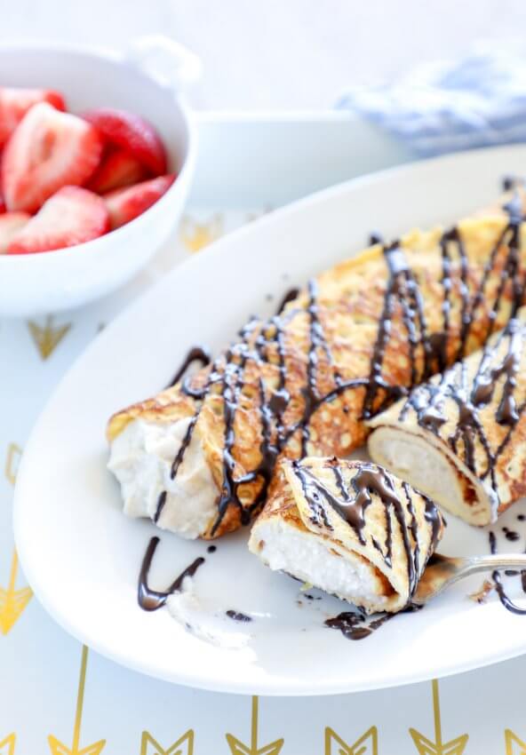 Keto Cannoli Stuffed Crepes - cut up and on a fork
