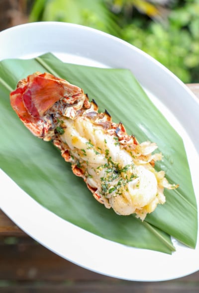 Keto Grilled Lobster Tails with Creole Butter on banana leaf