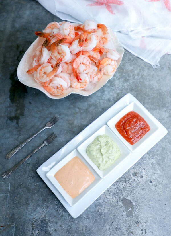 keto shrimp cocktail with 3 sauces on concrete background