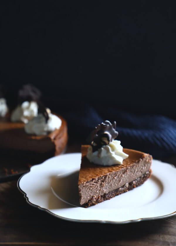 keto chocolate hazelnut cheesecake slice with whipped cream garnish