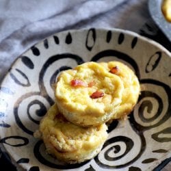 Keto Bacon & Egg Onion Cups piled on a patterned plate