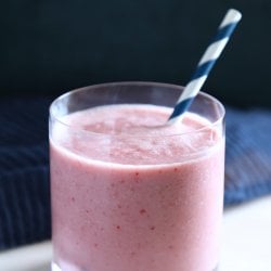 Keto Strawberry Vanilla Smoothie in a glass with a blue and white straw