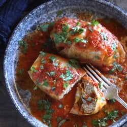 keto stuffed cabbage in the instant pot on a blue plate with a fork