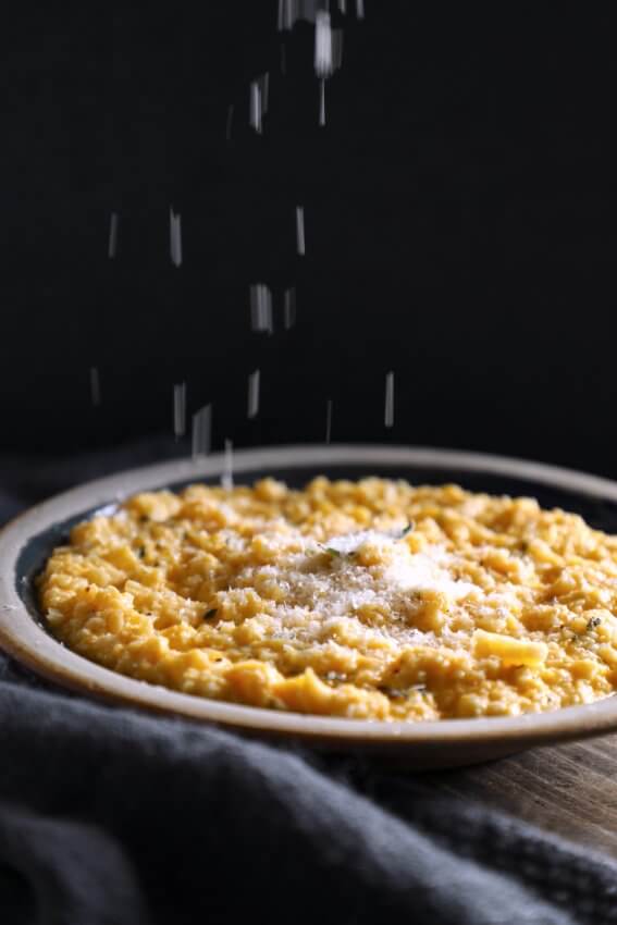 Keto butternut squash risotto with parmesan raining down onto it