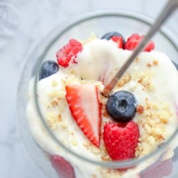 Keto No Bake Cheesecake Parfaits top view with blueberries and sliced strawberries