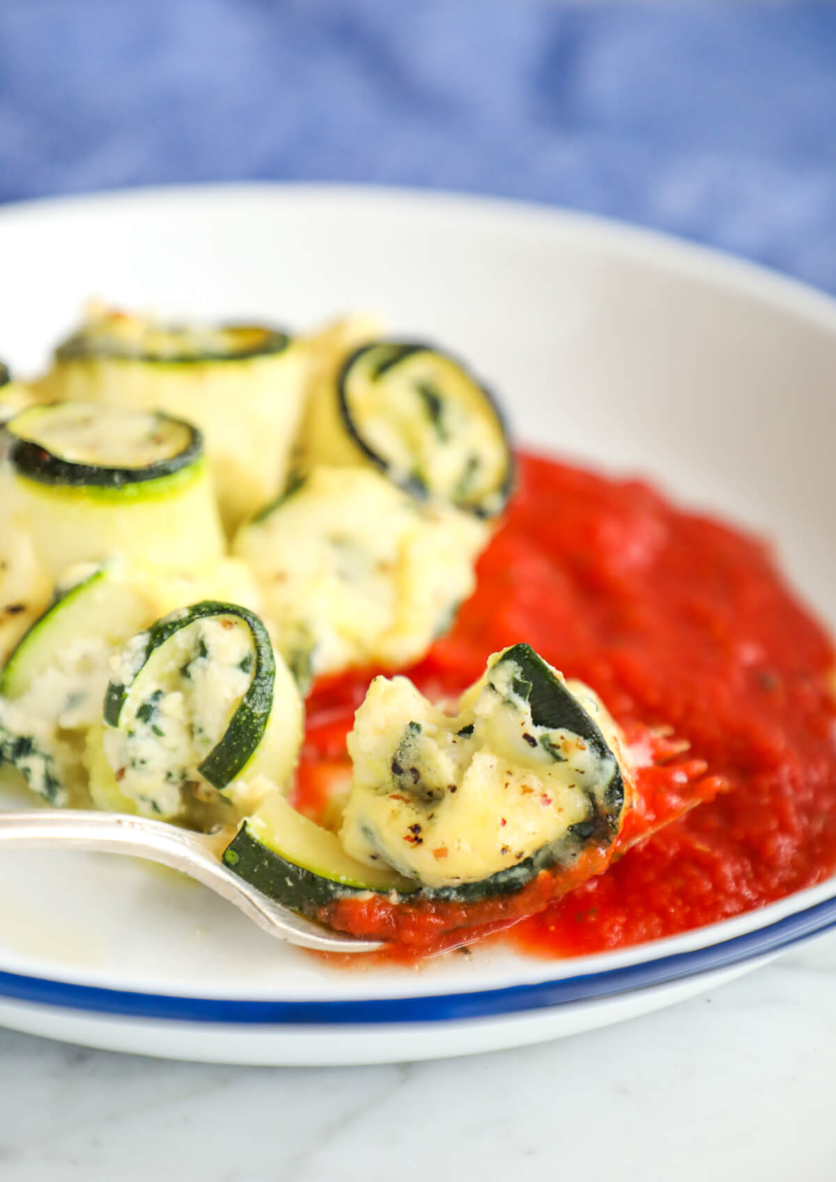 Keto Zucchini Rollatini on a fork with marinara sauce