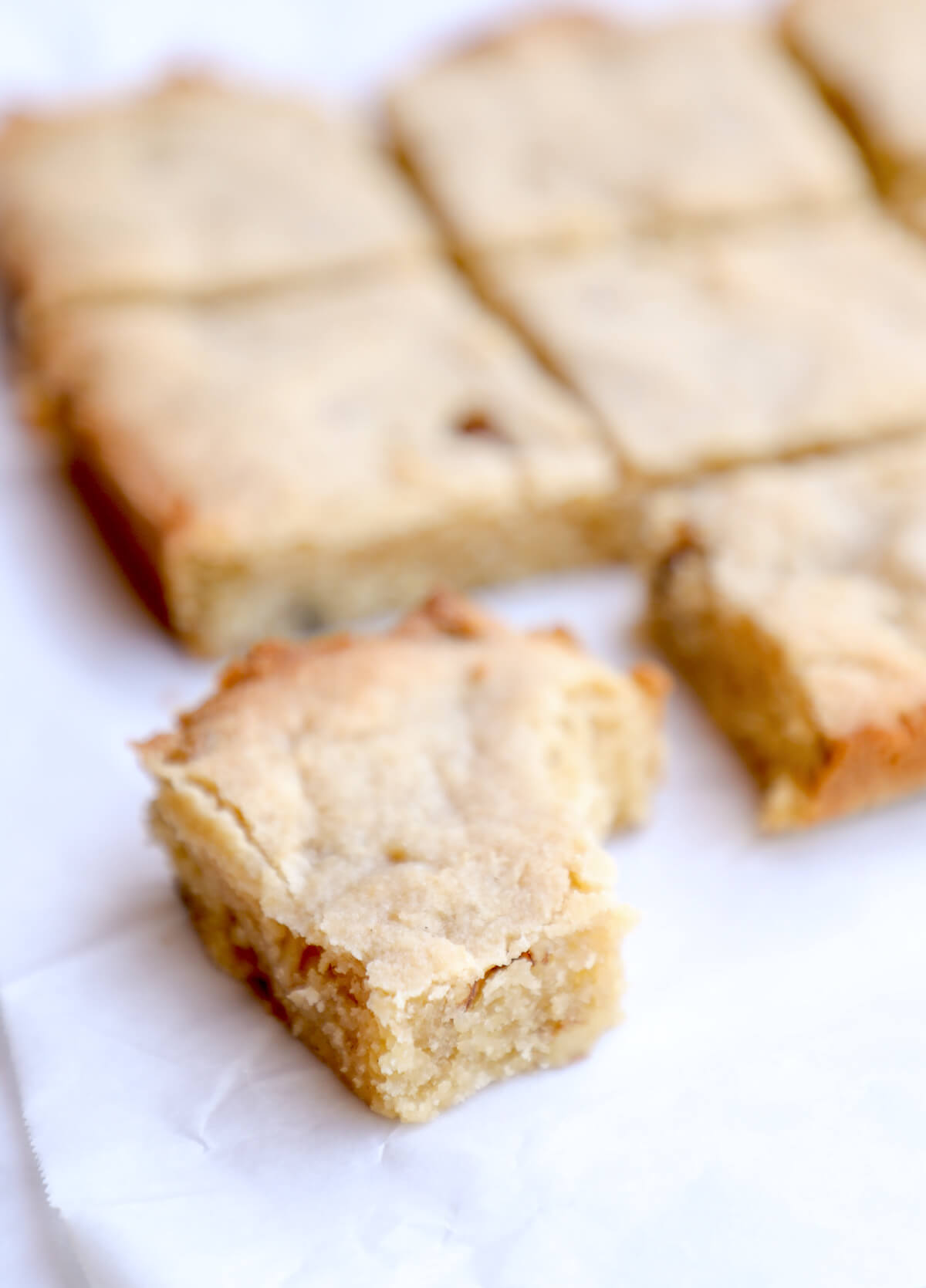Close up of a gluten free blondie with a bite taken out of it