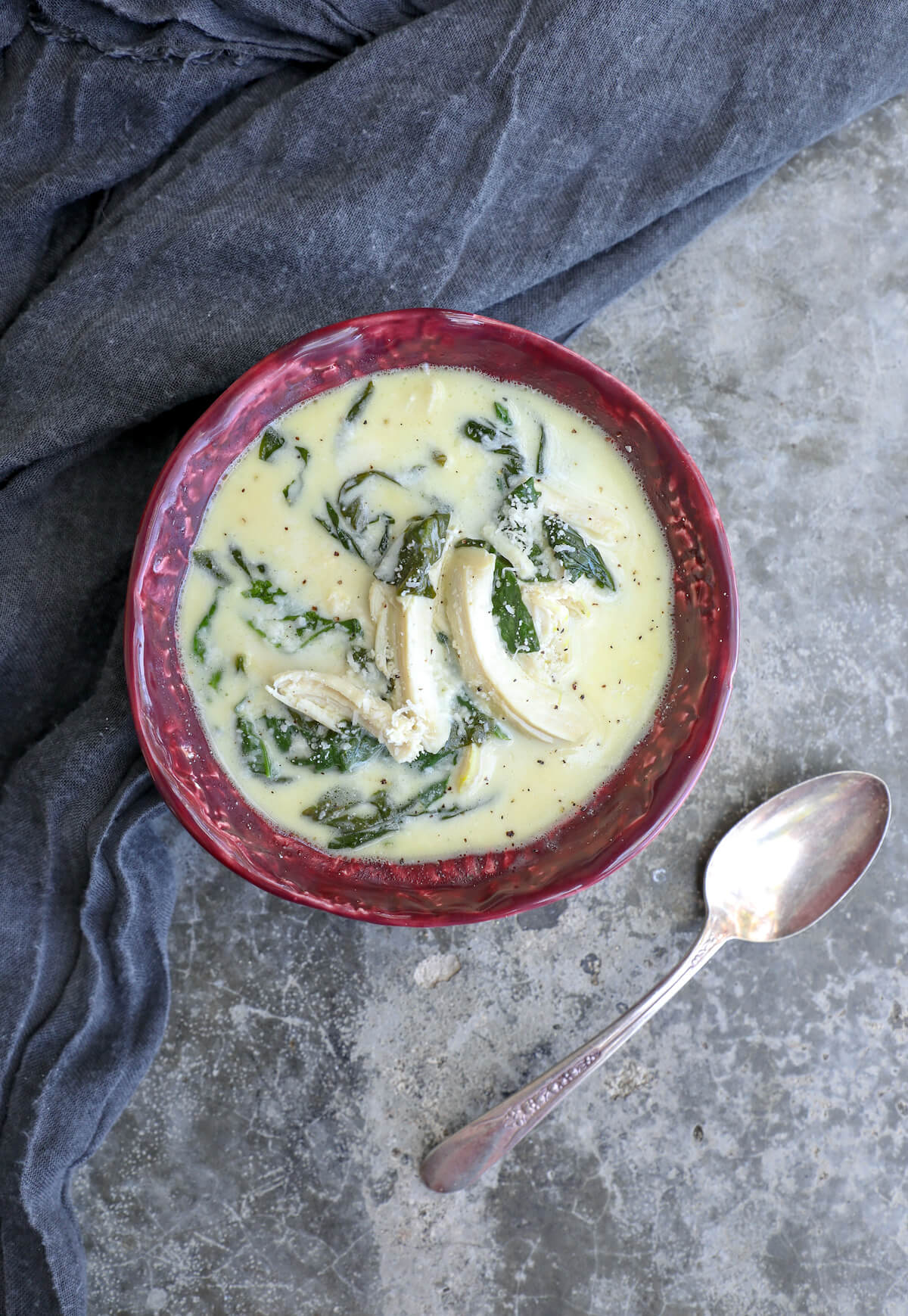 keto chicken Florentine soup shot from above with an antique silver spoon in the frame