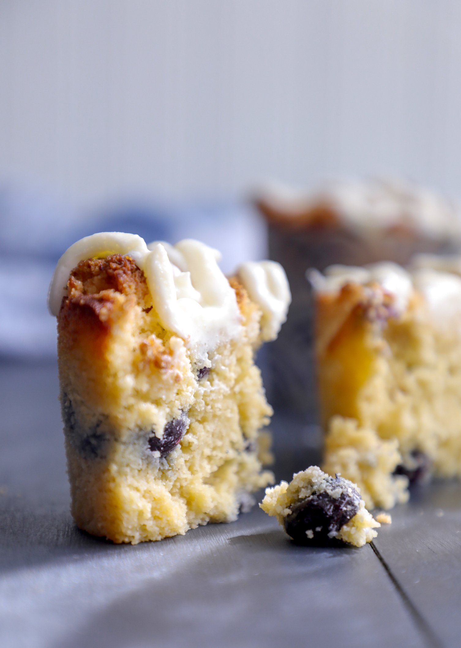 Keto Blueberry Muffins cross section with dripping lemon glaze