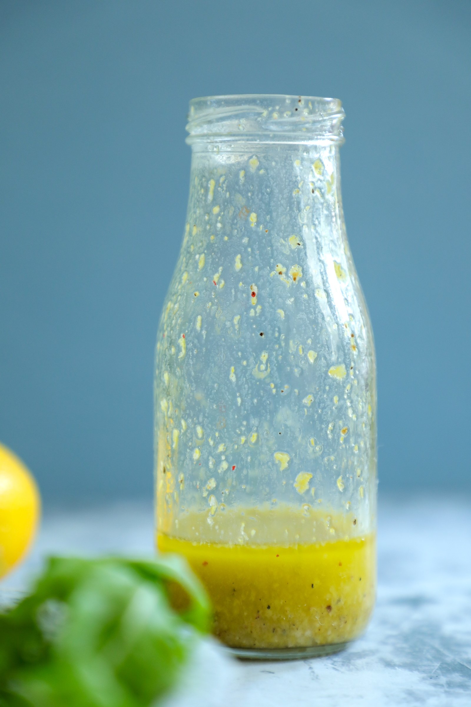 Keto lemon Dressing in a glass jar after shaking