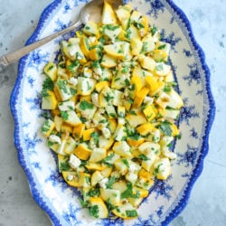 keto summer squash salad on a blue and white serving platter