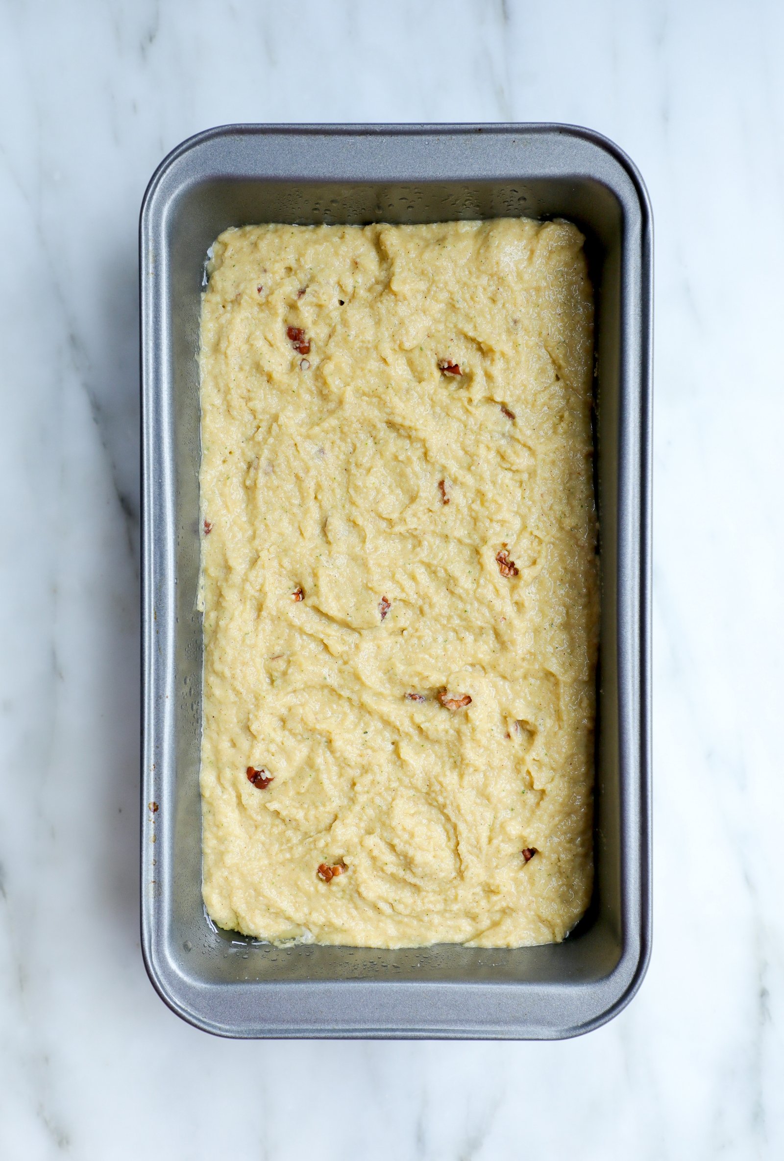Bread pan with keto zucchini bread batter before baking