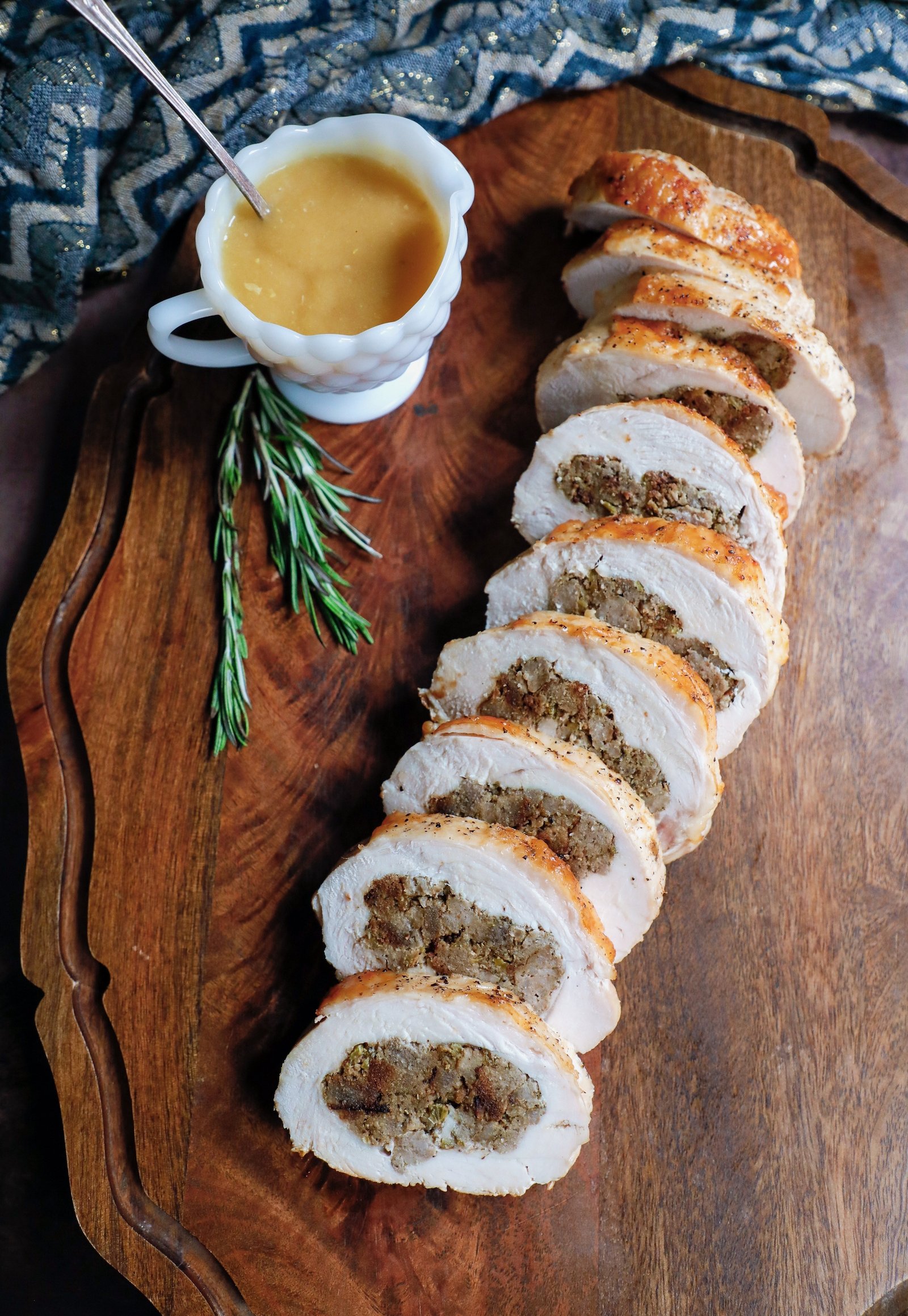 slices of turkey roulade arranged on a wooden serving board