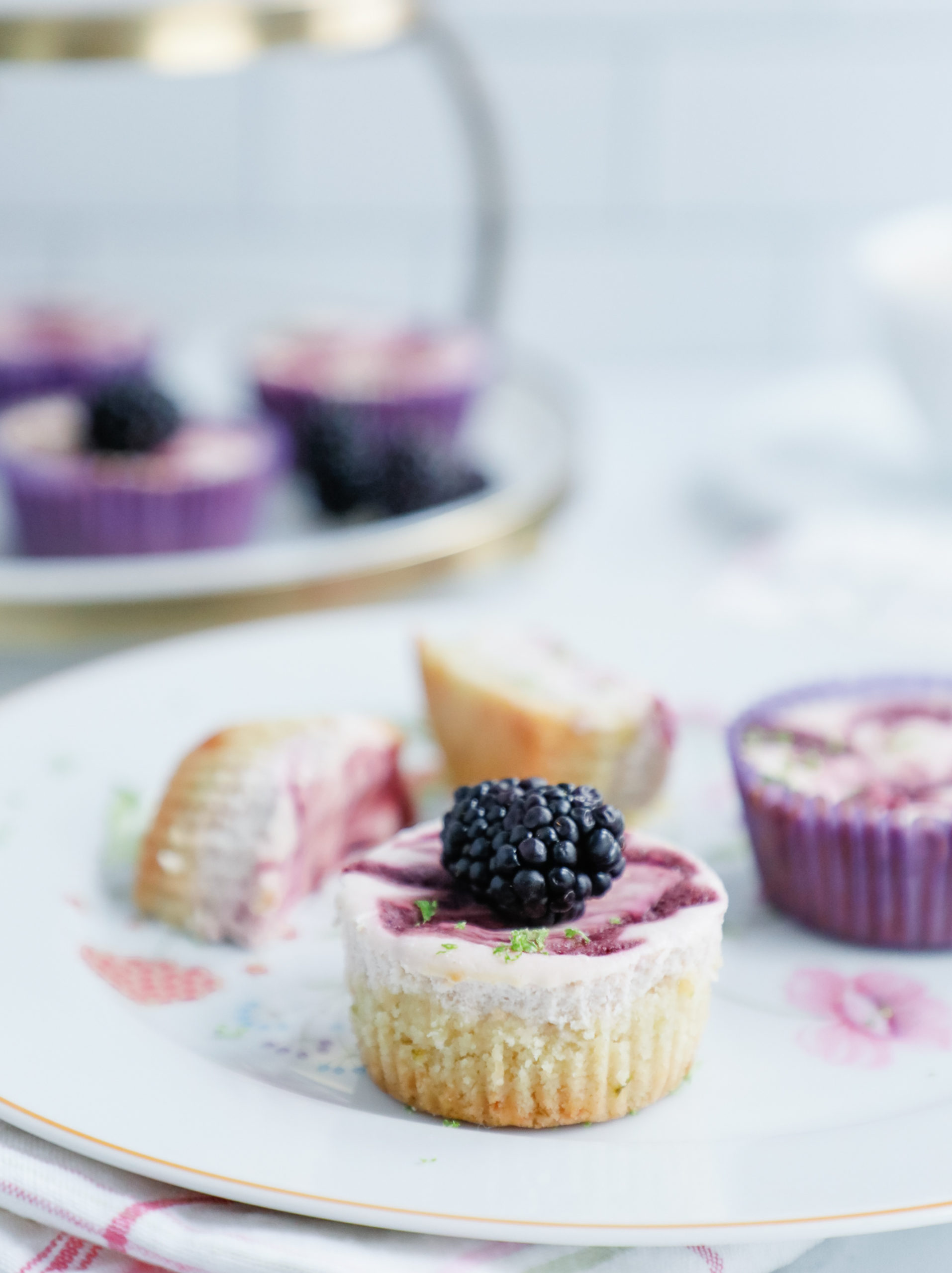 Blackberry Lime Cheesecakes with a blackberry garnish on a flowered plate